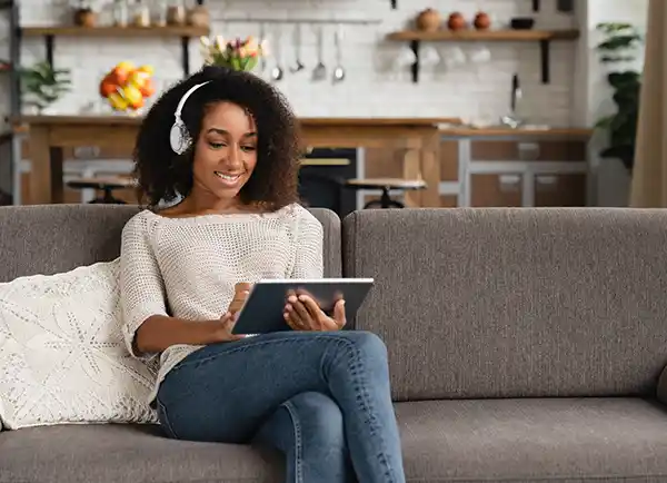 girl with tablet watching online through IPTV Norden